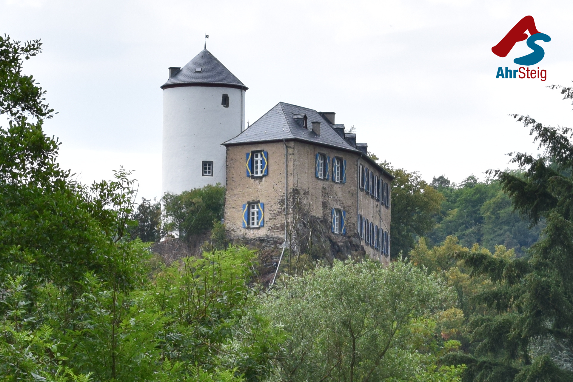 Ahrsteig-Kreuzburg Die Kreuzburg in Altenahr-Kreuzberg umgeben von Wald und Bergen.